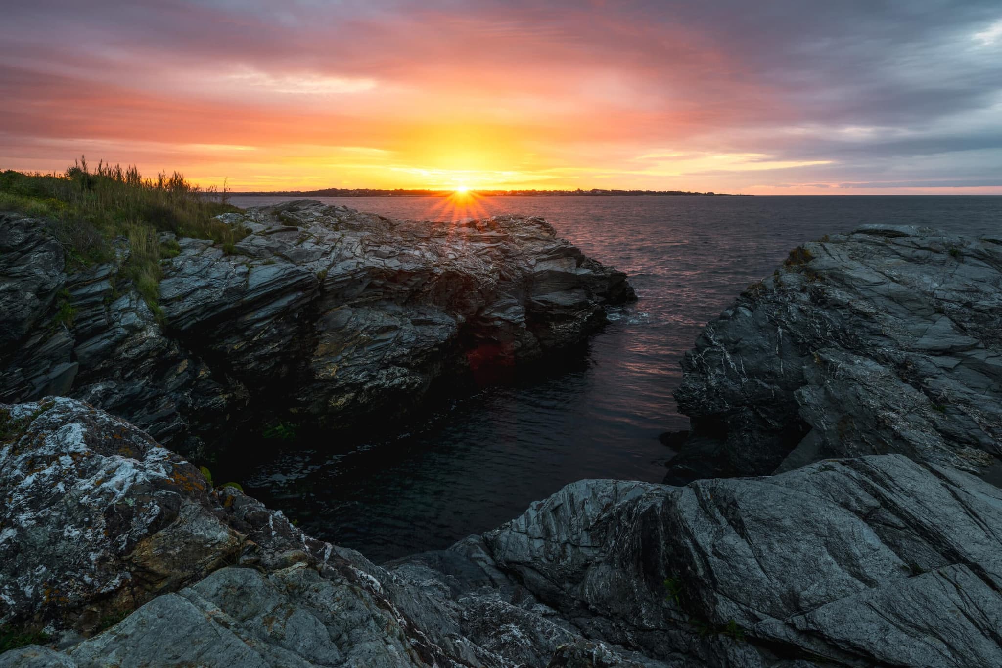 Sun setting over the rocks at Beavertail State Park