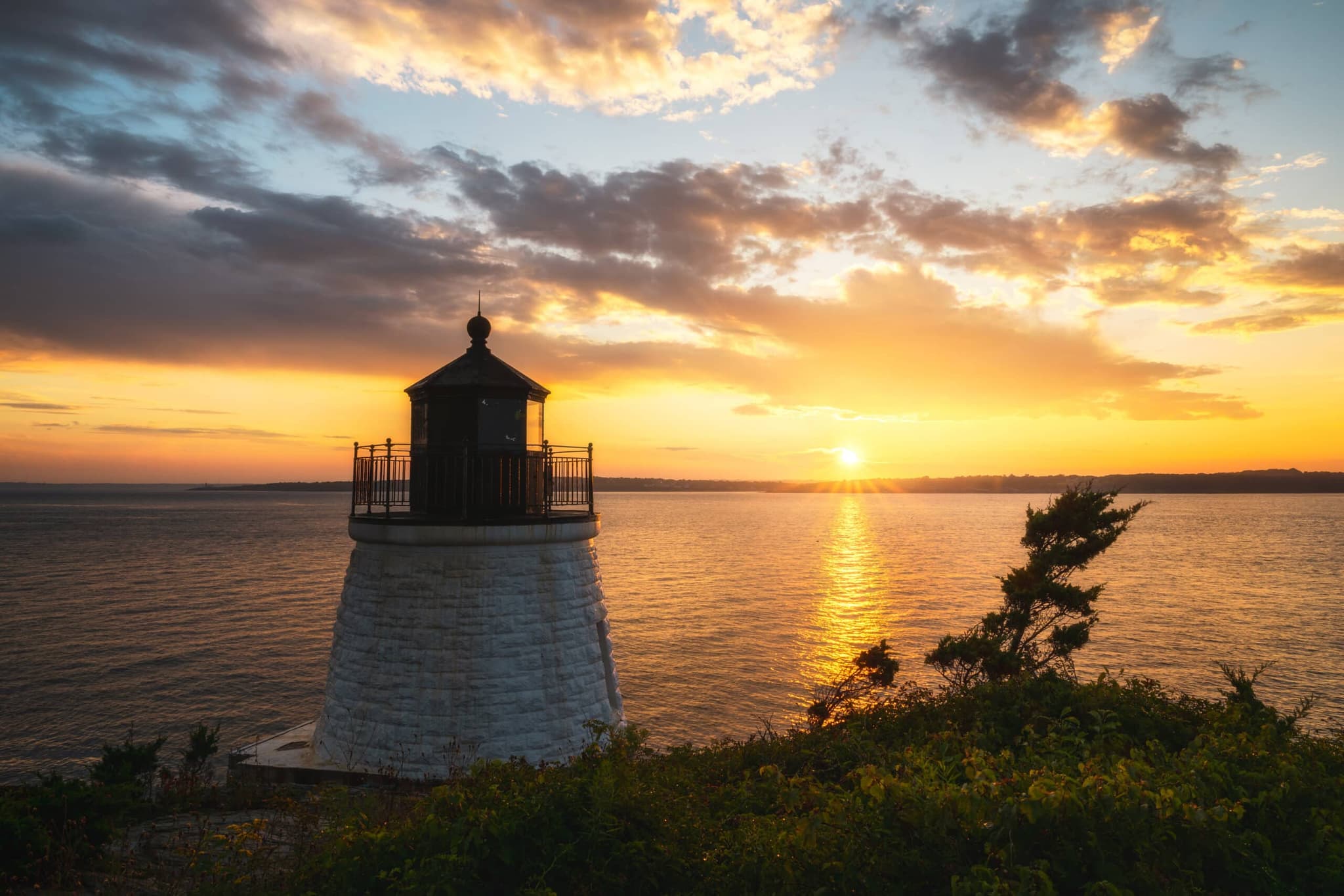 Castle Hill Lighthouse in Newport at sunset