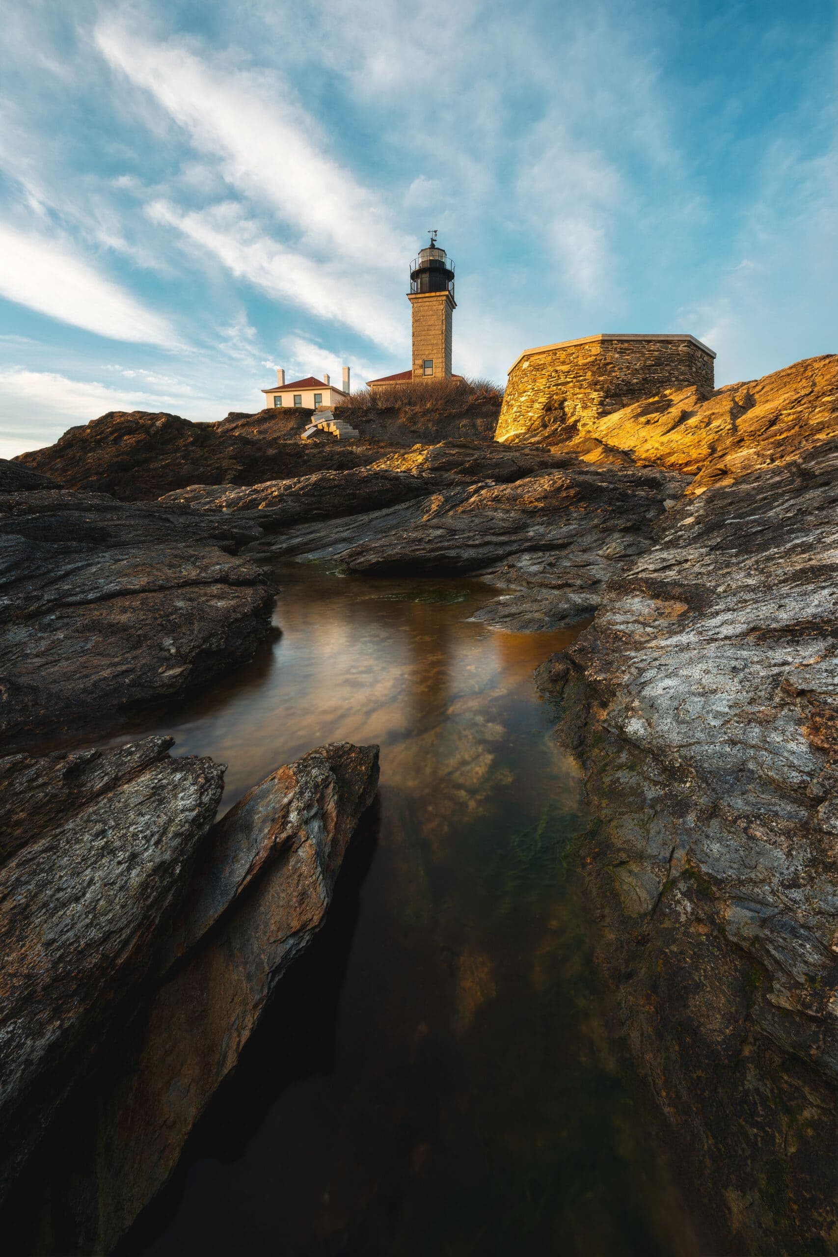 Beavertail Lighthouse above the rocky shore in Jamestown