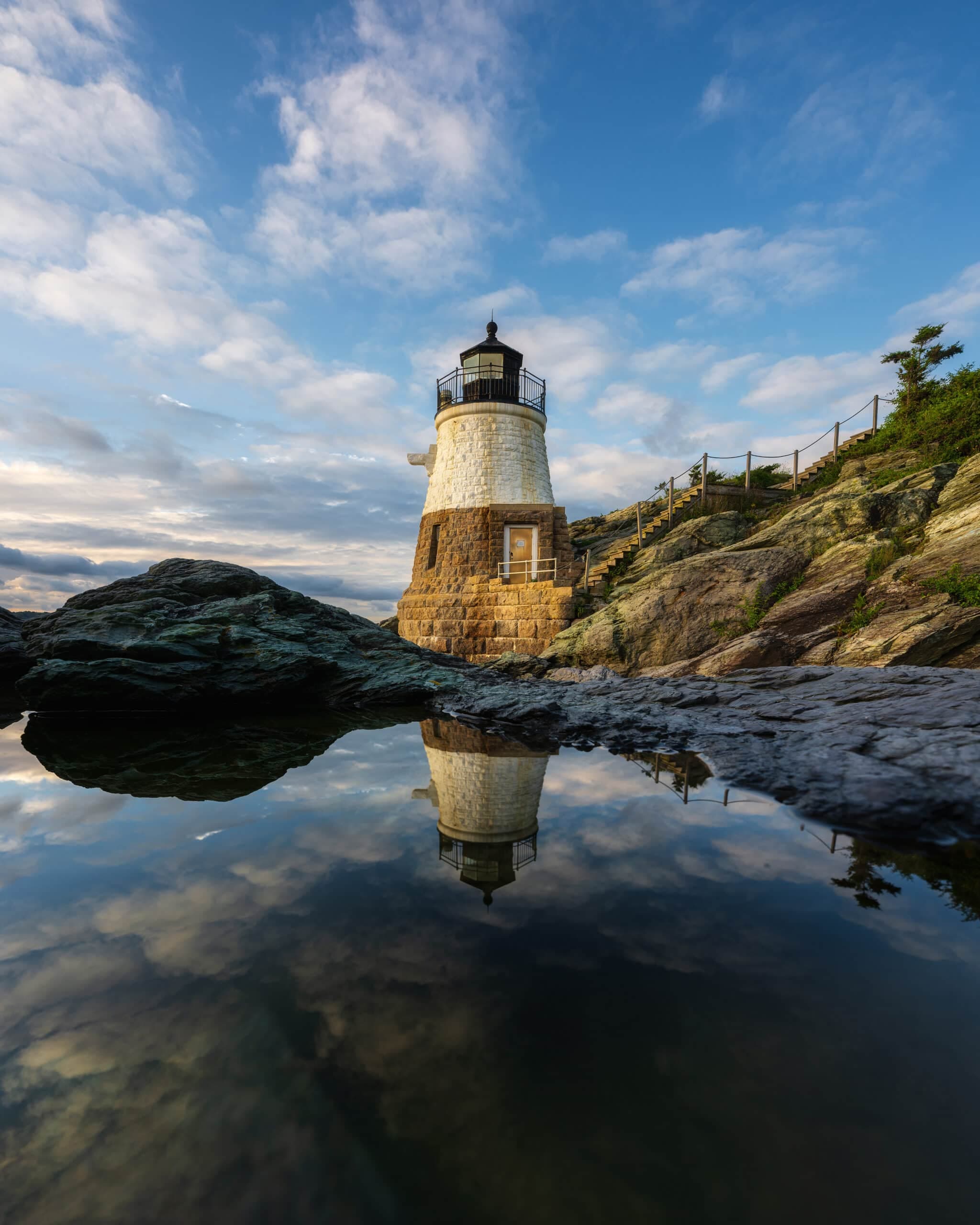 Castle Hill Lighthouse reflected in a still pool in Newport